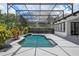 Backyard pool area with a screened enclosure, lush landscaping, and an outdoor seating at 10849 Emerald Chase Dr, Orlando, FL 32836