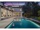 A gorgeous backyard pool featuring a screened-in enclosure and a stunning view of the home at 10849 Emerald Chase Dr, Orlando, FL 32836