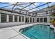 A luxury backyard featuring a large screened pool area, ample lounge space, and an outdoor area at 10849 Emerald Chase Dr, Orlando, FL 32836
