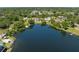 Aerial view of a beautiful lakefront property surrounded by lush trees and neighborhood homes at 1103 Lindley Cove Cir, Deland, FL 32724
