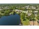 An aerial view showcasing a lake with lush trees, and waterfront homes in a serene community at 1103 Lindley Cove Cir, Deland, FL 32724