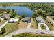 Aerial view of a lakeside single-Gathering home with manicured lawns and neighboring houses in view at 1103 Lindley Cove Cir, Deland, FL 32724