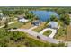 Wide aerial view of a neighborhood featuring a lakeside house with well-maintained lawns and paved roads at 1103 Lindley Cove Cir, Deland, FL 32724