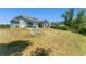 An expansive backyard with a well-maintained lawn featuring a modern house and patio at 1103 Lindley Cove Cir, Deland, FL 32724