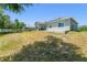 Large backyard with a covered patio, a manicured lawn, and a contemporary house exterior at 1103 Lindley Cove Cir, Deland, FL 32724