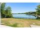 Backyard view overlooking a large blue lake and verdant greenery with a black metal fence at 1103 Lindley Cove Cir, Deland, FL 32724