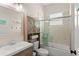 Bathroom featuring a shower and tub combination with tile surround, vanity with sink, and wood cabinet at 1103 Lindley Cove Cir, Deland, FL 32724