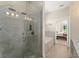 Luxurious bathroom with marble-tiled shower and soaking tub, adjacent to the main bedroom at 1103 Lindley Cove Cir, Deland, FL 32724