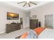 Well-appointed bedroom features a lake view, a mounted TV and matching dressers for storage at 1103 Lindley Cove Cir, Deland, FL 32724
