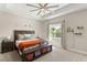 Cozy bedroom with a tray ceiling, a large window and bench seating at the foot of the bed at 1103 Lindley Cove Cir, Deland, FL 32724