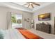 Bedroom features lake views from the window, plus a dresser with mounted TV and stylish decor at 1103 Lindley Cove Cir, Deland, FL 32724