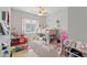 Bright bedroom features a loft bed, ceiling fan, and a window with natural light; great for or guests at 1103 Lindley Cove Cir, Deland, FL 32724