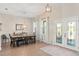 Elegant dining room with a large dining table, wood floors, and ample natural light at 1103 Lindley Cove Cir, Deland, FL 32724