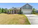 Charming two-story home with a well-manicured lawn, gray siding and a red front door at 1103 Lindley Cove Cir, Deland, FL 32724