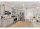 Bright kitchen features granite countertops, stainless steel appliances, and wood-look flooring at 1103 Lindley Cove Cir, Deland, FL 32724