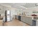 Open kitchen with granite countertops, stainless appliances, and seamless flow to the living area at 1103 Lindley Cove Cir, Deland, FL 32724