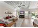 Inviting living room with modern décor, a large sectional sofa, and views of the serene lake at 1103 Lindley Cove Cir, Deland, FL 32724