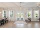 Bright and spacious living room featuring wood floors, large windows, and stylish french doors at 1103 Lindley Cove Cir, Deland, FL 32724
