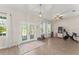 Bright and spacious living room featuring wood floors, large windows, and stylish french doors at 1103 Lindley Cove Cir, Deland, FL 32724