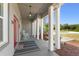 Inviting front porch with rocking chairs and decorative columns creating a cozy outdoor space at 1103 Lindley Cove Cir, Deland, FL 32724