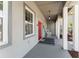 Inviting front porch with rocking chairs and decorative columns creating a cozy outdoor space at 1103 Lindley Cove Cir, Deland, FL 32724