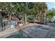 Untidy backyard area featuring trees, broken furniture, and weathered wooden structures at 1136 Lakewood Park Dr, Daytona Beach, FL 32117