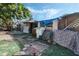 Run down backyard with weathered exterior, including a washing machine and old furniture at 1136 Lakewood Park Dr, Daytona Beach, FL 32117