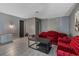 Living room with red tufted sofas, gray walls, and ceramic tile at 1136 Lakewood Park Dr, Daytona Beach, FL 32117
