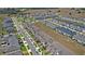 Beautiful aerial view of a neighborhood featuring townhomes, a community pool, and well-maintained landscaping at 1168 Lakeshore Breeze Pl, Kissimmee, FL 34747