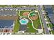 Aerial view of a community with a pool, playground, green space, and sidewalks at 1168 Lakeshore Breeze Pl, Kissimmee, FL 34747
