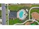 Aerial view of a community pool and playground with lounge chairs and ample green space at 1168 Lakeshore Breeze Pl, Kissimmee, FL 34747