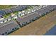 Aerial view of townhomes in a residential community, highlighted by sidewalks, manicured landscaping, and green spaces at 1168 Lakeshore Breeze Pl, Kissimmee, FL 34747