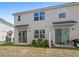 View of home's backyard and patio with sliding glass doors allowing easy access to indoor and outdoor spaces at 1168 Lakeshore Breeze Pl, Kissimmee, FL 34747
