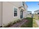 Backyard view of a house with a patio, garden, and well-maintained lawn at 1168 Lakeshore Breeze Pl, Kissimmee, FL 34747