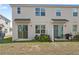 View of home's backyard and patio with sliding glass doors allowing easy access to indoor and outdoor spaces at 1168 Lakeshore Breeze Pl, Kissimmee, FL 34747