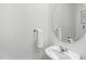 Bathroom featuring a single sink with round mirror, chrome fixtures, and neutral white walls at 1168 Lakeshore Breeze Pl, Kissimmee, FL 34747