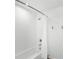 Neutral bathroom featuring a shower and tub with a white shower curtain at 1168 Lakeshore Breeze Pl, Kissimmee, FL 34747