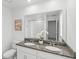 Bathroom with double sink vanity, granite countertops and large mirror at 1168 Lakeshore Breeze Pl, Kissimmee, FL 34747