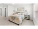 Cozy bedroom with a queen bed, stylish nightstands, lamps and neutral decor at 1168 Lakeshore Breeze Pl, Kissimmee, FL 34747