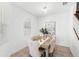 Bright dining room with a wooden table, beige upholstered chairs, and elegant floral artwork at 1168 Lakeshore Breeze Pl, Kissimmee, FL 34747