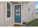 Stylish front door with decorative glass, complemented by a welcoming mat and potted plants at 1168 Lakeshore Breeze Pl, Kissimmee, FL 34747