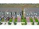 A row of townhomes with attached garages, brick driveways, and tidy landscaping creates a welcoming street view at 1168 Lakeshore Breeze Pl, Kissimmee, FL 34747