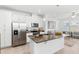 Kitchen with island and stainless-steel appliances overlooks the spacious living area, perfect for gatherings at 1168 Lakeshore Breeze Pl, Kissimmee, FL 34747