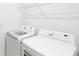 Bright laundry room features modern, white front-loading washing machine and dryer at 1168 Lakeshore Breeze Pl, Kissimmee, FL 34747