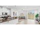 Bright and airy living space with tiled flooring, neutral decor, and access to the backyard at 1168 Lakeshore Breeze Pl, Kissimmee, FL 34747