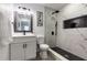 Modern bathroom with updated fixtures, white cabinets and a walk-in shower with eye-catching tile at 1313 Pine Ridge Dr, Daytona Beach, FL 32117