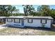 Charming single-story home featuring solar panels, a well-maintained lawn, and a freshly painted exterior at 1313 Pine Ridge Dr, Daytona Beach, FL 32117