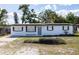 Quaint single-story home with new paint, lovely front yard, and an inviting entrance at 1313 Pine Ridge Dr, Daytona Beach, FL 32117