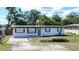Charming single-story home featuring a tidy front yard and a freshly painted exterior with lovely window boxes at 1313 Pine Ridge Dr, Daytona Beach, FL 32117