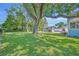 Expansive backyard with lush green lawn, mature trees, and detached garage at 1413 W Harvard St, Orlando, FL 32804